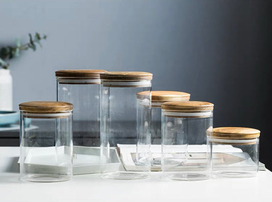 various glass containers with wooden lids